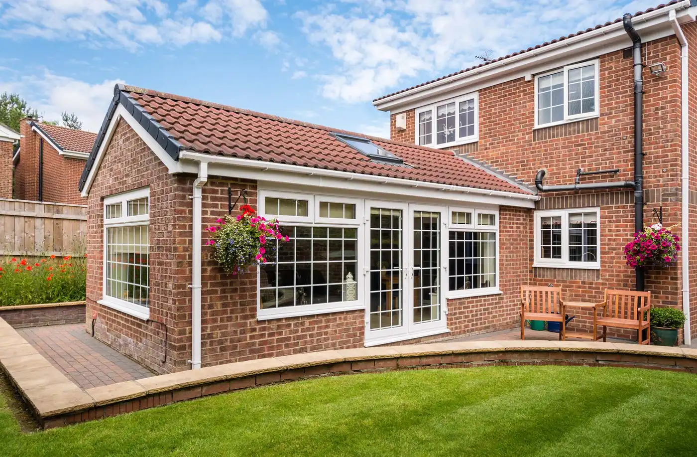 Modern Sunroom or conservatory extending into the garden, surrounded by a block paved patio