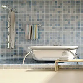 Blue tiled bathroom with silver bath and shower