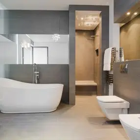 modern looking bathroom with large free standing bath and large mirrors