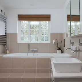 cream and white bathroom with 2 sinks