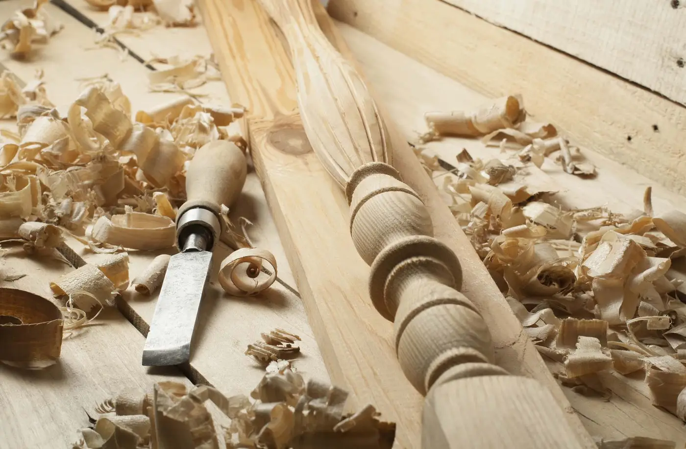 Carpentry concept.Joiner carpenter workplace. Old chisel and wooden workpiece on the table. Copy space for text.